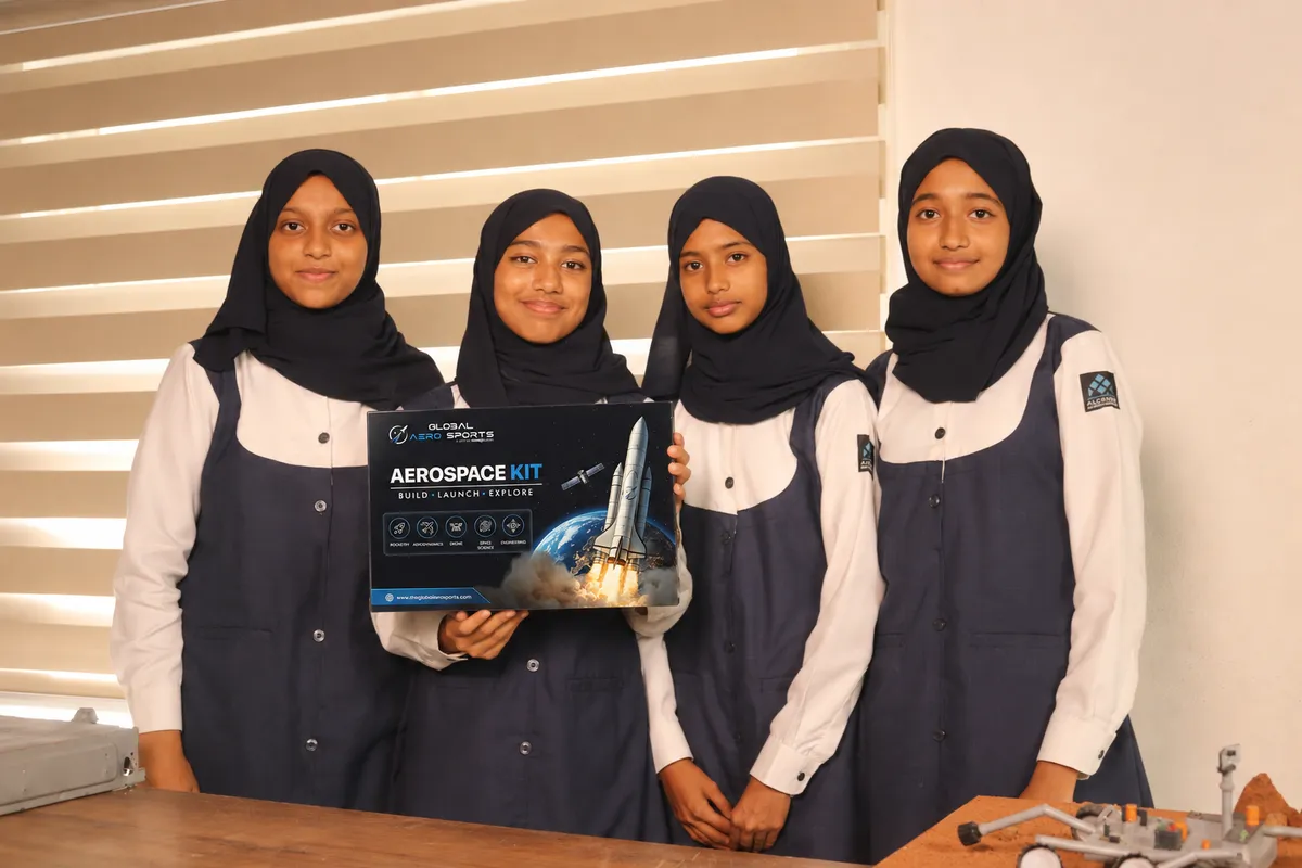 Students holding the Global AeroSports Aerospace Kit box